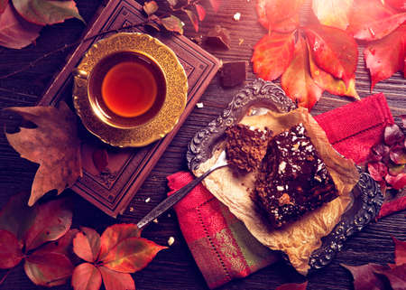 Chocolate cake and a cup of tea on a wooden backgroundの写真素材