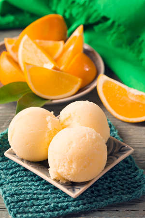 Homemade orange sorbet in a bowlの写真素材