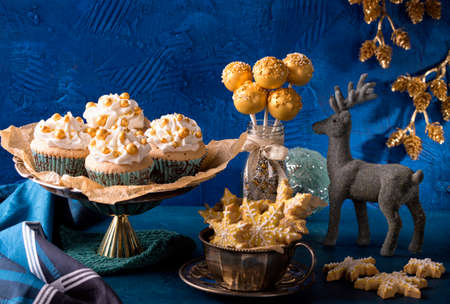 Golden sweets for christmas on a blue backgroundの写真素材