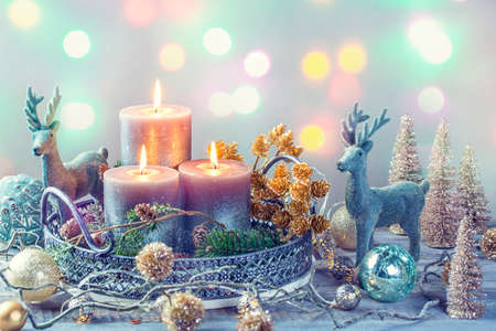 Candles and christmas decoration on a wooden backgroundの写真素材