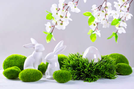 Ceramic easter rabbits and egg on a grey backgroundの写真素材