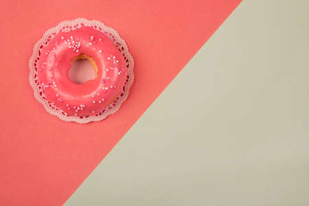 Sweet donut on a living coral paper backgroundの写真素材