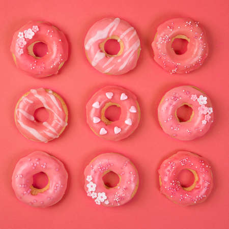 Sweet donuts on a living coral paper backgroundの写真素材