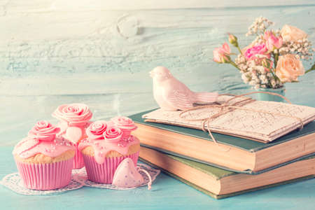 Cupcakes with pink flowers. Retro vintage still life.の写真素材