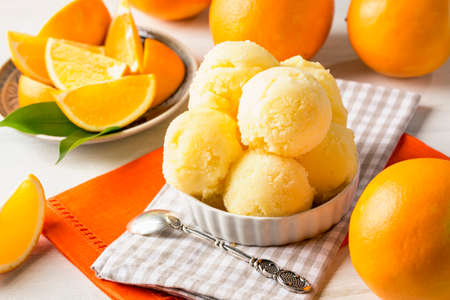 Orange sorbet in a white bowlの写真素材