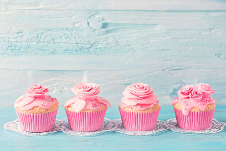 Pink  cup cakes on a blue backgroundの写真素材