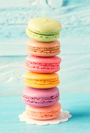 Colorful macarons on a blue wooden backgroundの写真素材