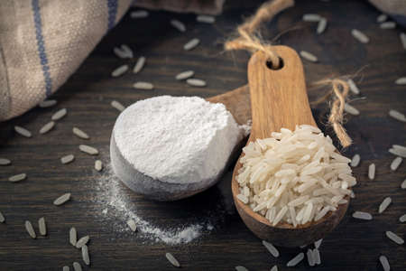 Rice flour in a wooden spoon isolated on a white backgroundの写真素材