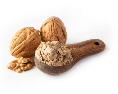 Walnut flour in the wooden spoon isolated on a white backgroundの写真素材