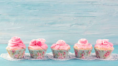 Pink  cup cakes on a blue backgroundの写真素材