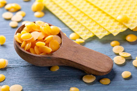 Beeswax pellets in the spoonの写真素材