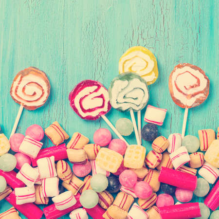 Pastel colored sweets on blue wooden background