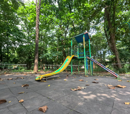 An old abandoned playground. Rusty swing and slide.の写真素材