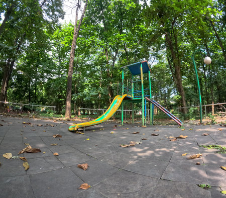 An old abandoned playground. Rusty swing and slide.の写真素材
