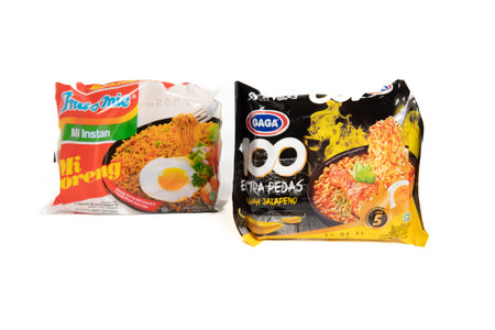 Jakarta, Indonesia - September 2, 2023: Two packs of Gaga instant noodle soup with jalapeno flavor and fried instant noodles on a white isolated background. Selective focusのeditorial素材