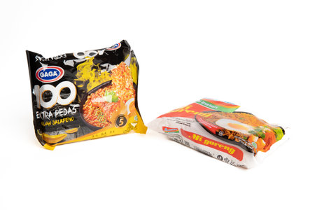 Jakarta, Indonesia - September 2, 2023: Two packs of Gaga instant noodle soup with jalapeno flavor and fried instant noodles on a white isolated background. Selective focusのeditorial素材