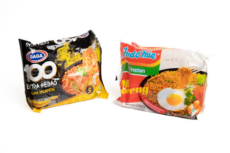 Jakarta, Indonesia - September 2, 2023: Two packs of Gaga instant noodle soup with jalapeno flavor and fried instant noodles on a white isolated background. Selective focusのeditorial素材