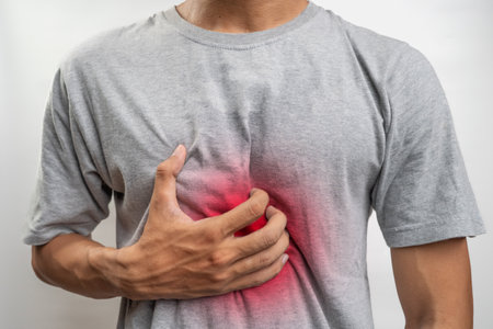 Men experience symptoms of burning in the middle of the chest due to increased stomach acid. Health and medical concept. Pain points are highlighted in red. isolated white backgroundの写真素材