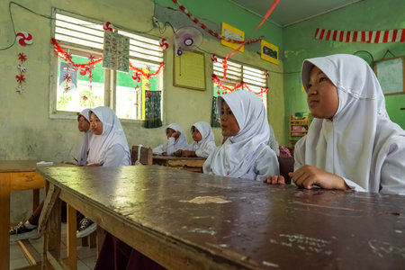 Banten, Indonesia - December 18 2023 : A group of Indonesian elementary school children carrying out learning activities in the morning while sitting in classのeditorial素材