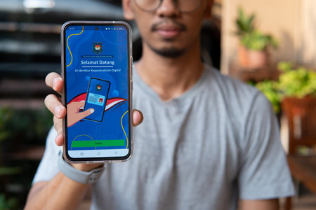 Jakarta, Indonesia - 15 December 2023 : Display of the digital State Population Identity (IKD) application. Indonesian Resident Identity Card replacement application, with a blurred backgroundのeditorial素材