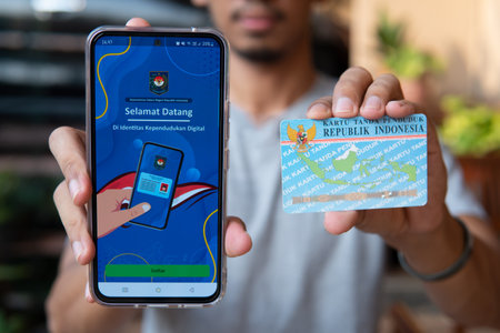 Jakarta, Indonesia - 15 December 2023 : Display of the digital State Population Identity (IKD) application. Indonesian Resident Identity Card replacement application, with a blurred backgroundのeditorial素材