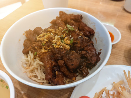 Chicken Leg Noodles served in a dish on a wooden tableの写真素材