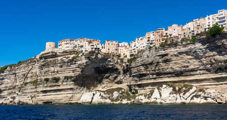Landscape of Bonifacio city, Corsica. Buildings and houses on cliff from sea view.の写真素材