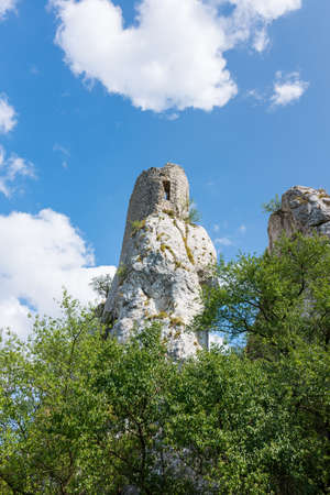 White rock in forest, national park, green trees, blue sky with clouds.の写真素材