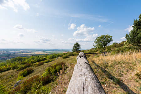 Landscape of village taken from wood railing, with trees and grass.の写真素材
