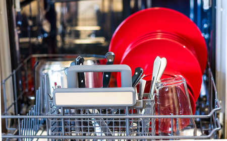 Look into dishwasher with the clean dish. Clean plate placed in kitchen cleaning machineの写真素材