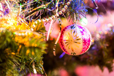 Detail of christmas decoration hangs on the tree. Christmas tree with pink, gold color and christmas ballの写真素材