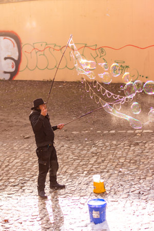 PRAGUE, CZECH REPUBLIC - 8.12.2018: Bubble artist is making soap bubbles on Prague city street.のeditorial素材