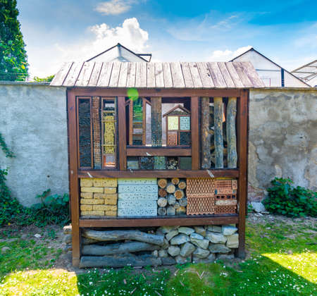 Insect hotel. Wooden house for insect, bug, bees. Decorative animal home, concept of ecological and...