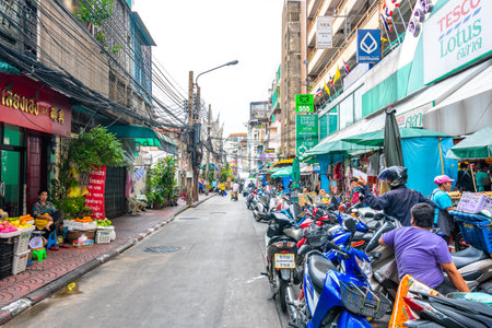 BANGKOK, THAILAND - 1.11.2019: Streets in the China town, Bangkok city. Traffic on street with the market on side. Heavy transportation, cars and motorbikes. Famous tourist destination in Bangkok.のeditorial素材