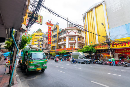 BANGKOK, THAILAND - 1.11.2019: Streets in the China town, Bangkok city. Traffic on street with the market on side. Heavy transportation, cars and motorbikes. Famous tourist destination in Bangkok.のeditorial素材