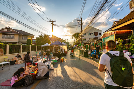 CHIANG MAI, THAILAND - 3.11.2019: Night market in Chiang Mai city shortly after sunset. Tourist are walking on the road. Thai sellers in the stall on side. Souvenirs and streetfood, summer day.のeditorial素材