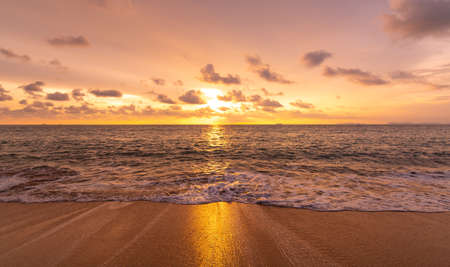 Beautiful sunset above sea or ocean. Vibrant and soft colors, magic light. Small clouds on the sky,...