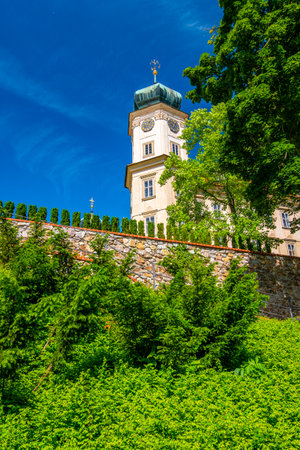 Historical chateau at Mnisek pod Brdy city, Czech Republic. View of ancient building with towers, built in gothic style. Sunny summer day, blue sky and vibrant colors.のeditorial素材