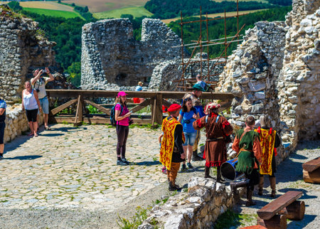 Cachtice, Slovakia - 4.7.2020: Tourists are visiting ruin of medieval castle Cachtice. Famous castle known from legend about blood lady Bathory. Summer weather, blue sky.のeditorial素材