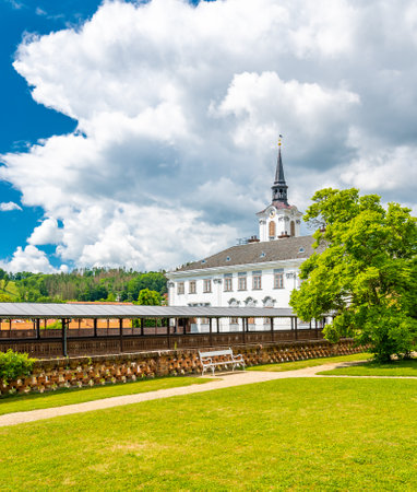 Lysice castle, Czech Republic. Famous baroque castle built in 14th century. Beautiful formal garden, palm trees and flowers. Promenade near the castle. Sunny day, dramatic clouds before storm.のeditorial素材
