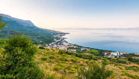 Aerial view of Tucepi town, Croatia. Makarska - Dalmatia region. View of city, sea and isle ind the background. Sunrise time.の写真素材