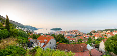 Panoramic view of sunrise over old town of Dubrovnik. Ancient city wall and Minceta tower. Famous tourist destination in Croatia. Summer morning, soft warm light.  .の写真素材