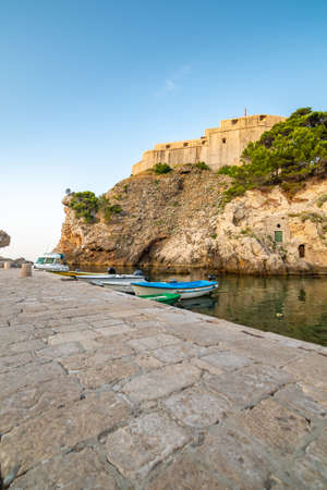 Dubrovnik old town small west harbor with boats. Near is the Lovrijenac fortress. Summer weather, morning soft light. Part of  .の写真素材