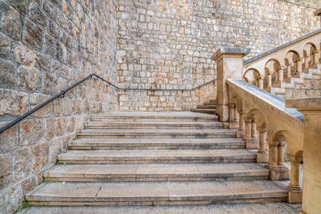 Entrance to the old city of Dubrovnik after Pilar gate. Small ancient street with stairs and old city walls.  .の写真素材