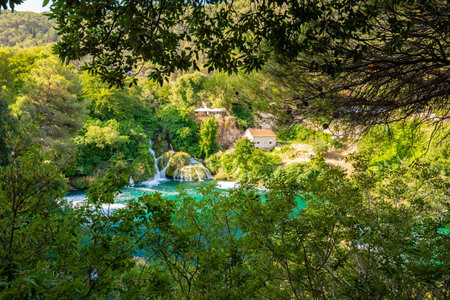 Waterfalls at Krka river, Croatia. Part of the Skradinski Buk waterfall. Famous place in nature park - beautiful tourist destination in Croatia. Fresh green nature, summer weather.の写真素材