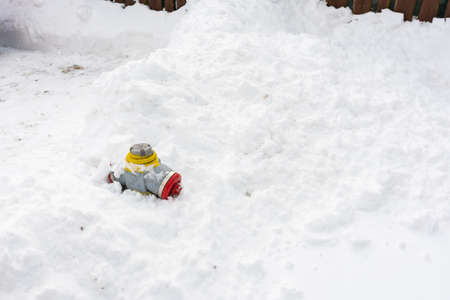 Fire hydrant covered with big amount of snow.の写真素材