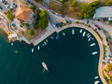Top down aerial drone view to Sibenik city harbor, croatia. Sea water with boats and yacht. Walking...