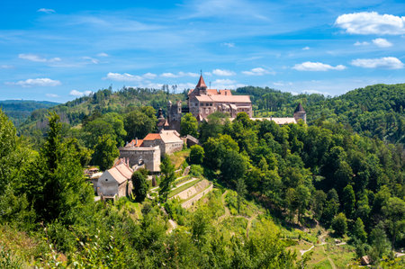 Outdoor view of Pernstejn castle near the Nedvedice village, Czech Republic. Fairytale castle on hill during summer day. Big stone walls and towers.のeditorial素材