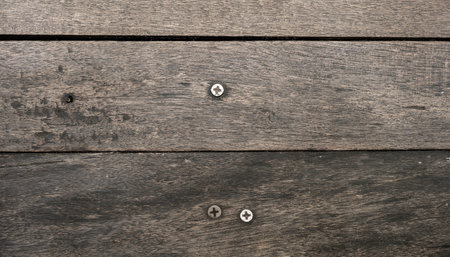 Texture of old wood with screw inside. Dark brown color.