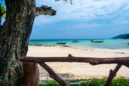 Long tailed boats near tropical beach at Ko Phi Phi, Thailand. Tropic beach with white sand and turquoise water, concept of vacation in paradise.の写真素材